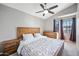 Main bedroom with wood bed frame and ceiling fan at 1436 E Rosemonte Dr, Phoenix, AZ 85024