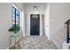 Bright entryway with a herringbone tile floor and a black front door at 1436 E Rosemonte Dr, Phoenix, AZ 85024