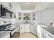 Bright kitchen featuring white shaker cabinets and gray countertops at 1436 E Rosemonte Dr, Phoenix, AZ 85024