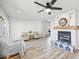 Cozy living room with fireplace, wood beam mantle and hardwood floors at 1436 E Rosemonte Dr, Phoenix, AZ 85024