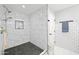 Updated shower with marble tile and a built-in shelf at 1436 E Rosemonte Dr, Phoenix, AZ 85024