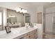 Elegant bathroom with double sinks, a large mirror, and a walk-in shower at 15050 N Thompson Peak Pkwy # 1010, Scottsdale, AZ 85260