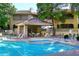 Community pool with covered patio and spa at 15050 N Thompson Peak Pkwy # 1010, Scottsdale, AZ 85260