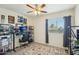 Bright bedroom with a ceiling fan, window coverings, and built-in shelving at 15081 N 176Th Ln, Surprise, AZ 85388