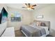 Spacious bedroom with a large bed, window with shutters, and TV at 15081 N 176Th Ln, Surprise, AZ 85388