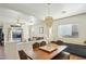 Open dining room with a wood table and modern chandelier at 15081 N 176Th Ln, Surprise, AZ 85388