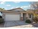 Single-story home with a two-car garage and nicely landscaped front yard at 15081 N 176Th Ln, Surprise, AZ 85388