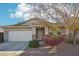 Single-story home with a two-car garage and landscaped front yard at 15081 N 176Th Ln, Surprise, AZ 85388