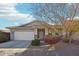 Single-story house with a two-car garage and nicely landscaped front yard at 15081 N 176Th Ln, Surprise, AZ 85388