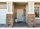 Inviting front entrance with stone pillars and a charming door at 15081 N 176Th Ln, Surprise, AZ 85388