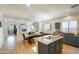 Modern kitchen with dark cabinets, an island, and stainless steel appliances at 15081 N 176Th Ln, Surprise, AZ 85388