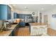 Stylish kitchen with dark blue cabinets, an island, and a breakfast bar at 15081 N 176Th Ln, Surprise, AZ 85388