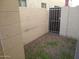 Small backyard with gravel and a gated entrance at 15818 N 25Th St # 116, Phoenix, AZ 85032