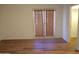 Bedroom with wood-look floors and double doors leading to patio at 15818 N 25Th St # 116, Phoenix, AZ 85032