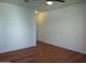 Bright bedroom with wood-look floors and ceiling fan at 15818 N 25Th St # 116, Phoenix, AZ 85032