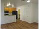 Living room with hardwood floors, kitchen island, and wood cabinets at 15818 N 25Th St # 116, Phoenix, AZ 85032