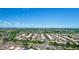 Aerial view of a neighborhood with houses, roads and distant mountains at 15913 W Elm St, Surprise, AZ 85374