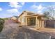 Landscaped backyard with covered patio and brick accents at 15913 W Elm St, Surprise, AZ 85374