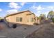 Backyard view of home with covered patio and AC unit at 15913 W Elm St, Surprise, AZ 85374