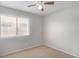 Simple bedroom with ceiling fan and neutral walls at 15913 W Elm St, Surprise, AZ 85374