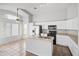 Bright kitchen featuring white cabinets and an island at 15913 W Elm St, Surprise, AZ 85374