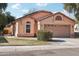 Tan two-car garage home with solar panels at 1616 N 125Th Ln, Avondale, AZ 85392