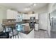 U-shaped kitchen with granite counters and stainless steel appliances at 1616 N 125Th Ln, Avondale, AZ 85392