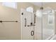 Walk-in shower with glass enclosure and built-in seat at 16955 W Holly St, Goodyear, AZ 85395