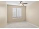 Well-lit bedroom featuring carpet, ceiling fan and window blinds at 16955 W Holly St, Goodyear, AZ 85395