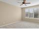 Bright bedroom with neutral walls, carpet flooring, and plantation shutters at 16955 W Holly St, Goodyear, AZ 85395