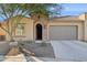 Single-story home with a two-car garage and desert landscaping at 16955 W Holly St, Goodyear, AZ 85395