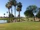 Picturesque golf course with lake, palms and mountains at 16955 W Holly St, Goodyear, AZ 85395