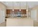 Kitchen island with granite countertops and dark wood cabinets at 16955 W Holly St, Goodyear, AZ 85395