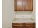 Laundry room with wooden cabinets and countertop at 16955 W Holly St, Goodyear, AZ 85395