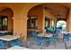 Relaxing community patio with tables, chairs, and ceiling fans at 16955 W Holly St, Goodyear, AZ 85395