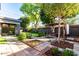 Landscaped backyard with patio, pergola, and spacious grass area at 1837 E Minnezona Ave, Phoenix, AZ 85016