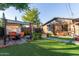 Backyard with pergola, patio furniture, and grassy lawn at 1837 E Minnezona Ave, Phoenix, AZ 85016