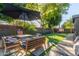 Relaxing patio with seating and umbrella, near the house at 1837 E Minnezona Ave, Phoenix, AZ 85016