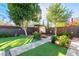 Landscaped backyard oasis with pergola, fire pit, and seating area at 1837 E Minnezona Ave, Phoenix, AZ 85016