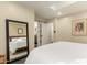 Spacious bedroom with large mirror reflecting the bed and access to the bathroom at 1837 E Minnezona Ave, Phoenix, AZ 85016