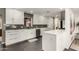 Modern kitchen with white cabinets, dark tile backsplash, and island at 1837 E Minnezona Ave, Phoenix, AZ 85016