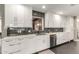 Modern kitchen with white cabinets, stainless steel appliances, and dark gray tile backsplash at 1837 E Minnezona Ave, Phoenix, AZ 85016