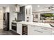 Modern kitchen features stainless steel appliances and white shaker cabinets at 1837 E Minnezona Ave, Phoenix, AZ 85016