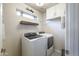 Bright laundry room with washer, dryer, and ample cabinet space at 1908 E Hawken Pl, Chandler, AZ 85286