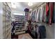 Well-organized walk-in closet with custom shelving and hanging space at 1908 E Hawken Pl, Chandler, AZ 85286