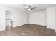 Bedroom with ceiling fan, wood-look tile, and access to bathroom at 2047 E Devon Rd, Gilbert, AZ 85296