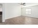 Bright bedroom with ceiling fan and wood-look tile flooring at 2047 E Devon Rd, Gilbert, AZ 85296