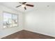 Bright bedroom with ceiling fan and wood flooring at 2047 E Devon Rd, Gilbert, AZ 85296