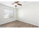 Well-lit bedroom featuring wood-look tile floors at 2047 E Devon Rd, Gilbert, AZ 85296