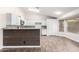 Modern kitchen with white cabinets and wood counter at 2047 E Devon Rd, Gilbert, AZ 85296